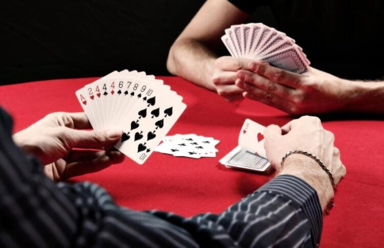 Rummy hands being played on a card table — how we test rummy apps